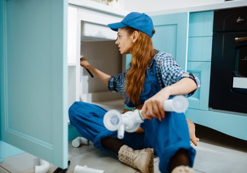 female-plumber-fixing-problem-with-drain-pipe-2021-08-28-05-13-47-utc.jpg